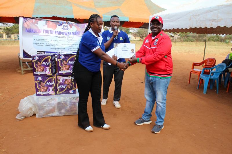 A county official presents a certificate at a youth empowerment forum