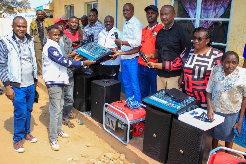Youth group members receive a sound mixer from county officials